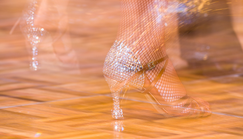 Blurred close up photo of a female dancer's shoes the heel being covered in rhinestones