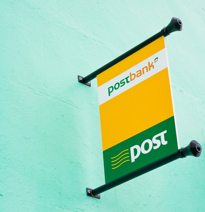 Close up photo of the sign of an Irish post office in green and yellow