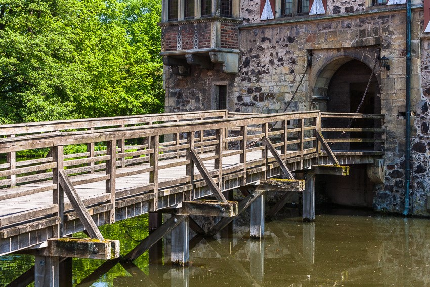 Detail photo of a wooden bridge crossing towards the medieval moated castle of Vischering, North Rhine-Westphalia, Germany