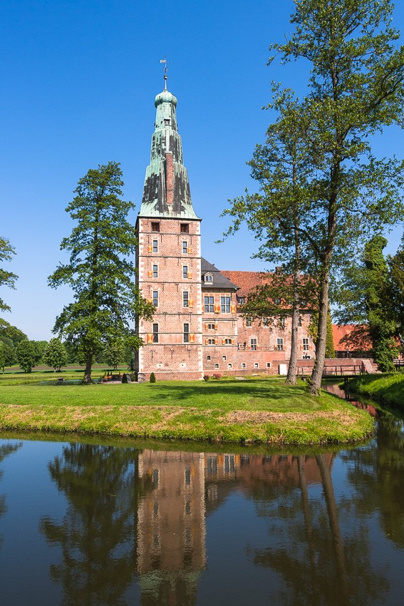 Photo of the moated Raesfeld Castle with lake and trees in North Rhine-Westphalia, Germany