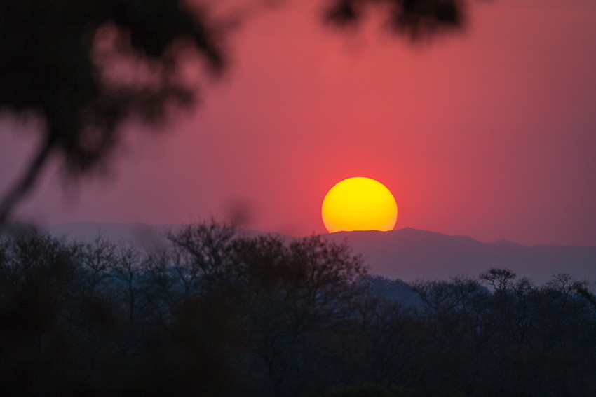 Photo of the sunset over the mountains in South Africa with a red sky