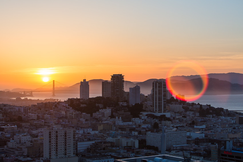 Photo of the skyline of San Francisco in California, USA at sunset with the Golden Gate Bridge