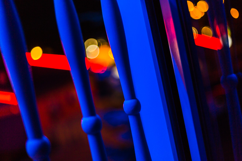 Abstract photo of a balcony railing in colorful blue and red